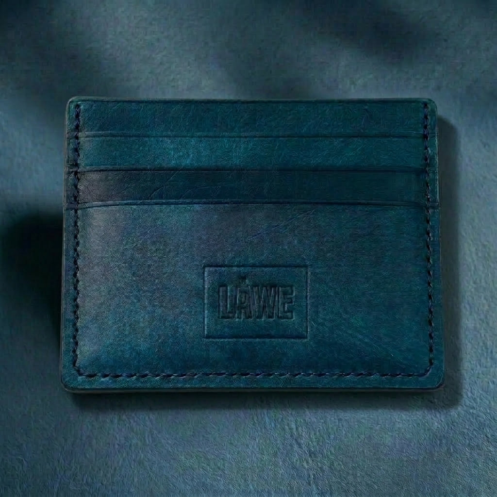 Blue leather card holder with 'LÅWE' branding on a blue background