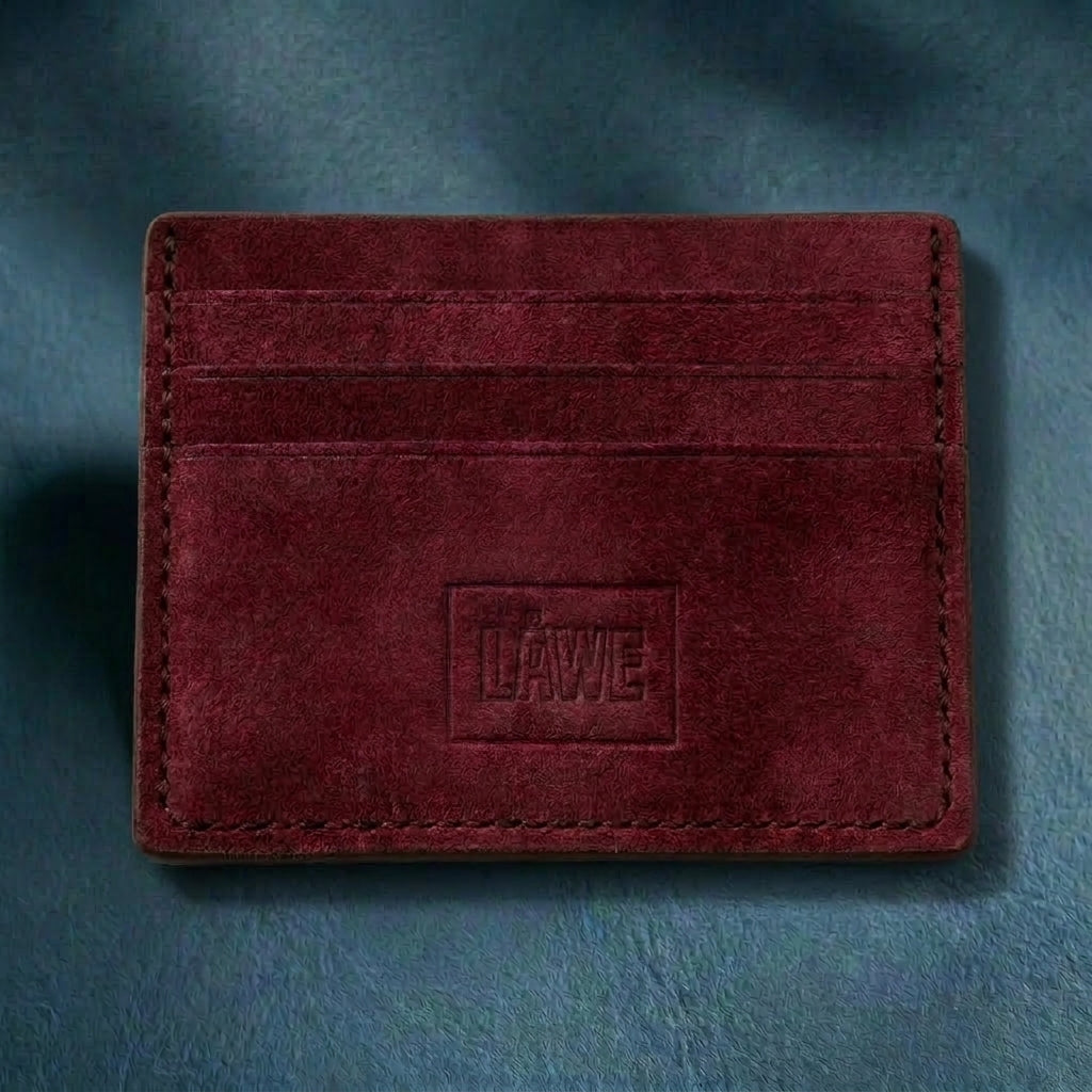 Burgundy leather cardholder with 'LÅWE' branding on a blue background