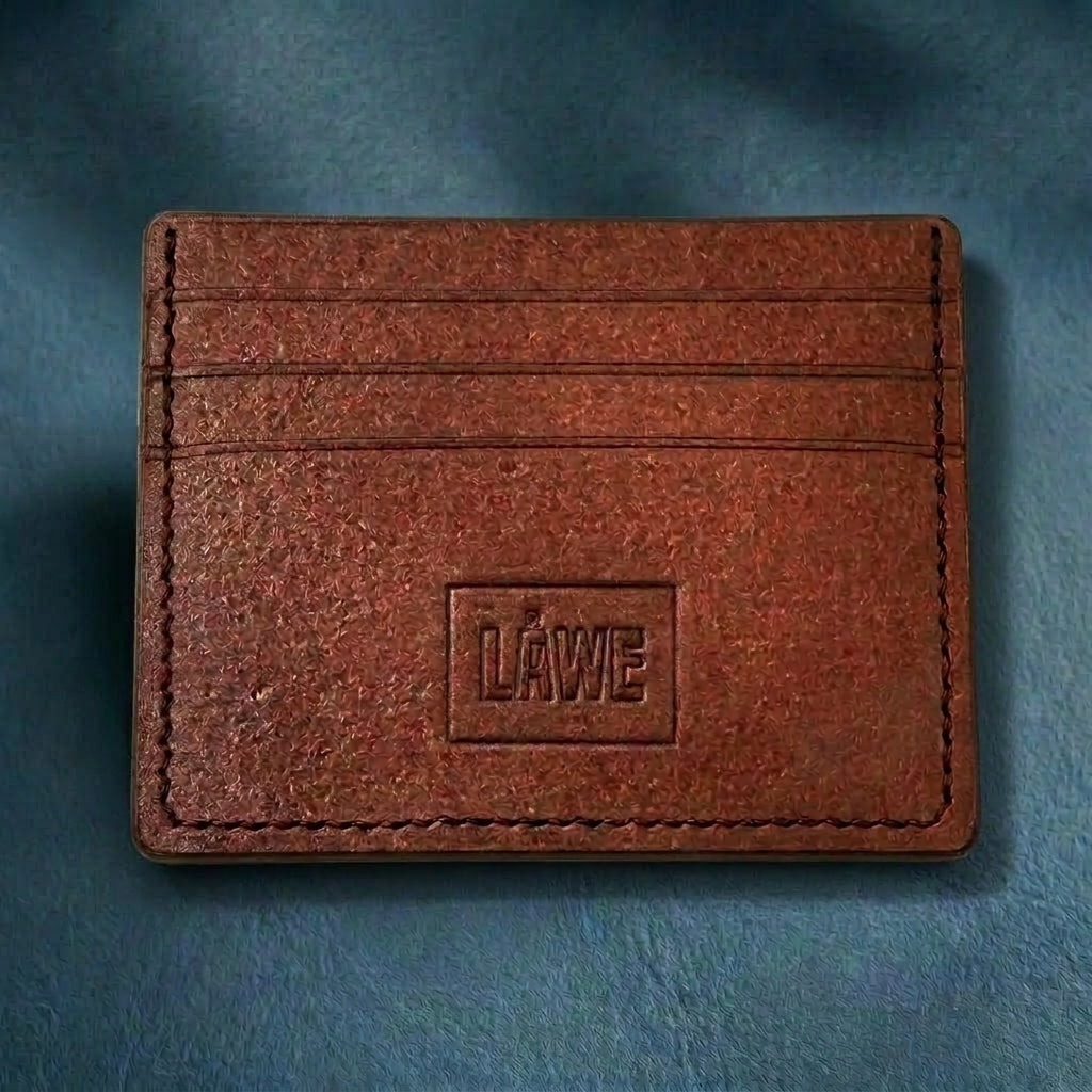 Brown leather cardholder with 'LÅWE' branding on a blue background