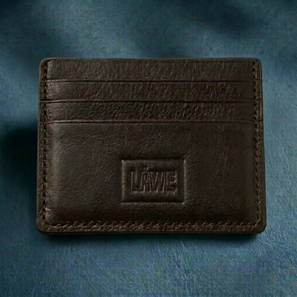 Dark brown leather cardholder with a brand logo on a textured blue background