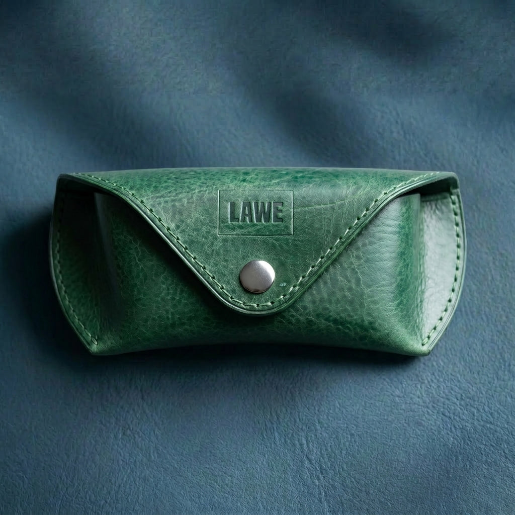 Green leather sunglasses case with 'LAWE' branding on a dark blue background