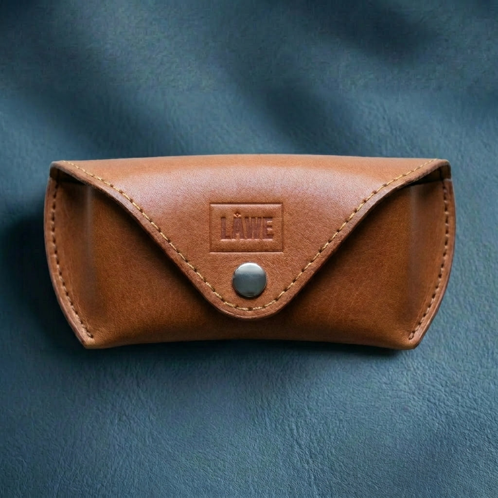 Brown leather case with a metal button on a blue background