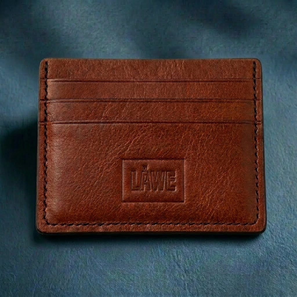 Brown leather cardholder with 'LÅWE' branding on a blue background