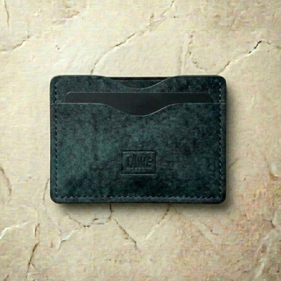 LÅWE slate leather cardholder on a beige marble surface